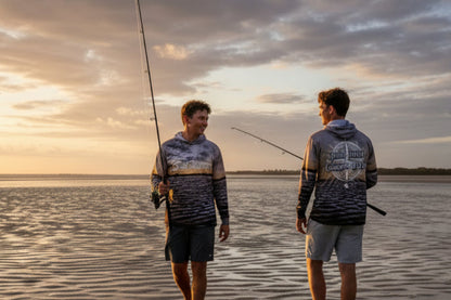 Two people wearing Last Water shirts by the water in the Gulf of Carpentaria