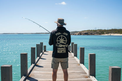 Man wearing Last Water D.P.S fishing hooded shirt while fishing from a jetty