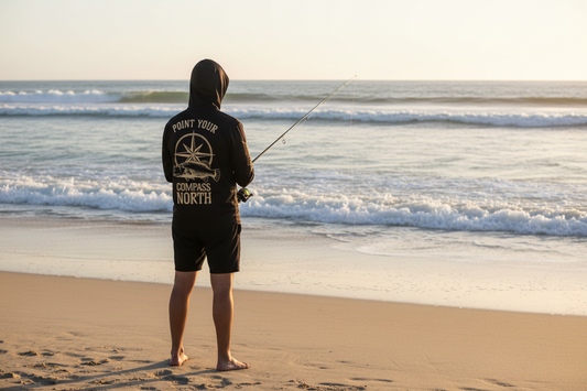 Man wearing Last Water D.P.S hooded fishing shirt while fishing from the beach